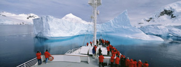 Tourists Standing on a Cruise Ship Watching at Iceberg, Antarctic Peninsula, Antarctica